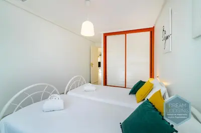 two beds in a room with a window at Falésia Park - Dream Lodging in Albufeira