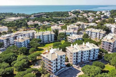 an aerial view of a city with buildings and the ocean at Falésia Park - Dream Lodging in Albufeira