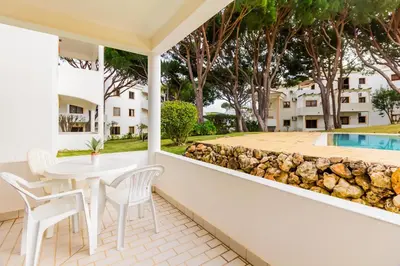 a bedroom with a large bed and a chair at Steps Algarve ☀ @ Praia da Falésia 300 meters in Albufeira