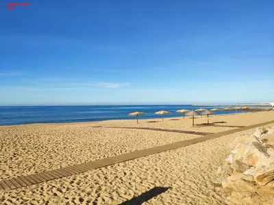 a group of umbrellas on a beach with the ocean at Alsol C 5361-1 in Quarteira