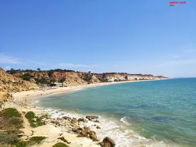 a view of a beach with rocks and the ocean at Alsol C 5361-1 in Quarteira