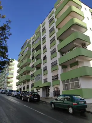 a green car parked in front of a building at Alsol C 5361-1 in Quarteira