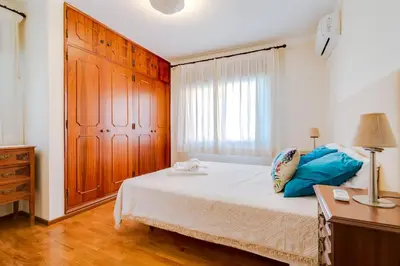 a bedroom with a bed and a dresser and a window at LovelyStay - Villa Mimi in Vilamoura
