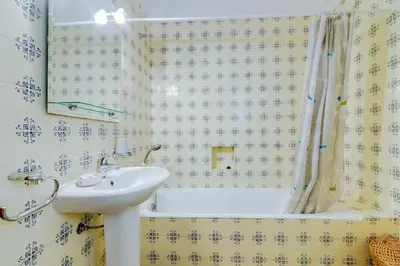 a bathroom with a sink and a bath tub at LovelyStay - Villa Mimi in Vilamoura