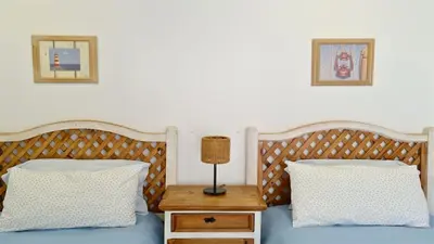 a bed with two pillows and a lamp on a table at Marina Parque 211-CleverDetails, Located in the Marina, Private Pool in Vilamoura