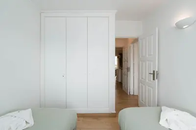 a bedroom with two beds and a sliding door at Sweet Old Village in Quarteira