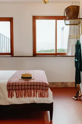 a bedroom with a table with a hat on it at THE MODERNIST, Architecture experience in Faro