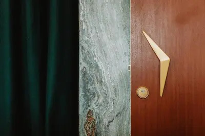 a wooden door with a handle next to a curtain at THE MODERNIST, Architecture experience in Faro