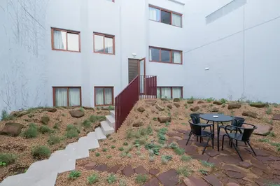 a patio with a table and chairs in front of a building at THE MODERNIST, Architecture experience in Faro