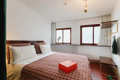 a bedroom with a bed with a red box on it at THE MODERNIST, Architecture experience in Faro