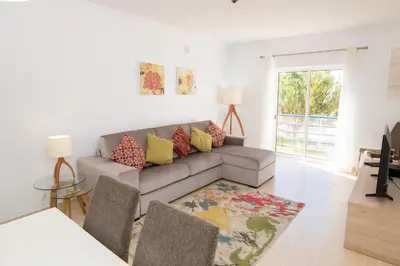 a living room with a couch and a table at Albufeira Sunny Apartment 2 With Pool by Homing in Galé