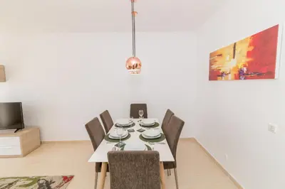 a dining room with a white table and chairs at Albufeira Sunny Apartment 2 With Pool by Homing in Galé