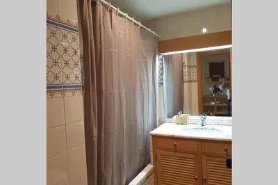 a bathroom with a sink and a shower curtain at Vilamoura Marina Extraordinary 70 m2 T1, Marina 200m , beach 300m in Vilamoura