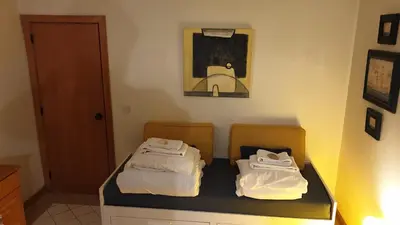 two beds in a room with a picture on the wall at Vilamoura Marina Extraordinary 70 m2 T1, Marina 200m , beach 300m in Vilamoura