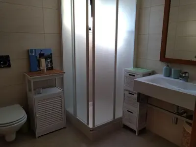 a bathroom with a shower and a toilet and a sink at J&J Home T2 next to Pinhal Velho, Terraces of Pinhal, Vilamoura in Quarteira
