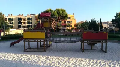 a playground with a slide in a park at J&J Home T2 next to Pinhal Velho, Terraces of Pinhal, Vilamoura in Quarteira