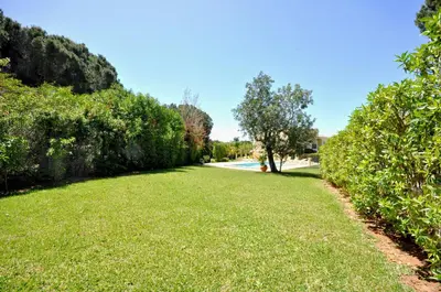 a swimming pool in front of a house at A stylish villa with a private pool, short drive from the centre, free AC Wifi in Quarteira