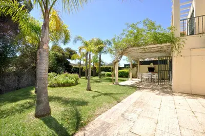 a house with a swimming pool in a yard at A stylish villa with a private pool, short drive from the centre, free AC Wifi in Quarteira