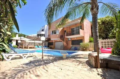 a resort with a swimming pool and a building at Spacious Retreat with Prime Location, Private pool, snooker, free AC Wifi in Quarteira
