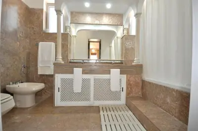 a white bathroom with a toilet and a sink at Spacious Retreat with Prime Location, Private pool, snooker, free AC Wifi in Quarteira