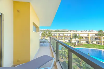 a balcony with a view of a resort at Jardins da Marina BI Albufeira Marina in Albufeira