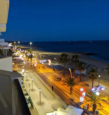 a view of a beach at night with street lights at Quarteira, Algarve - Seaview - Horizonte Mar in Quarteira