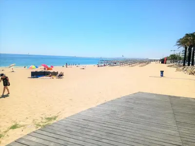 a beach with people on the sand and the ocean at T1 PonteMira 6 50M PRAIA VISTA MAR in Quarteira