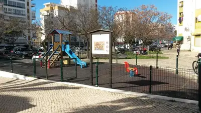a playground with a slide in a park at T1 Dunas 7 - Aconchegante, Wifi, 150mt Praia in Quarteira