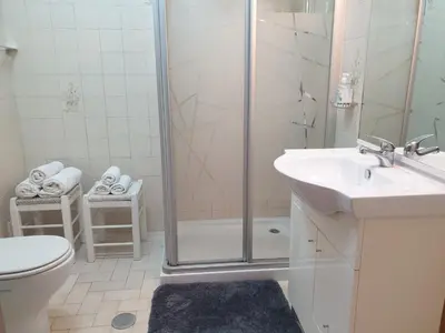 a bathroom with a shower and a toilet and a sink at Sunset Seaviews Albufeira in Albufeira