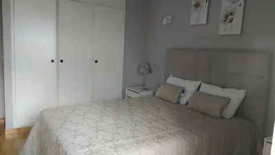 a bedroom with a large bed with white cabinets at Sunset Seaviews Albufeira in Albufeira