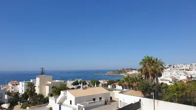 a view of a city and the ocean at Sunset Seaviews Albufeira in Albufeira