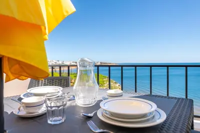 a living room with a couch and a table at Sunset Azul - Sea View - Free Wifi - By Bedzy in Albufeira