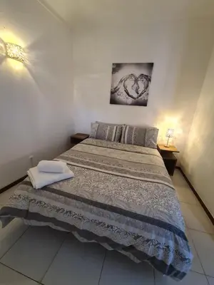 a bedroom with a large bed with two towels on it at 1 bedroomed Apartment - Ocean View - Oura - Beach in Albufeira