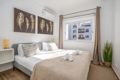 a bedroom with a large bed and a window at #034 Tebay by Home Holidays in Albufeira
