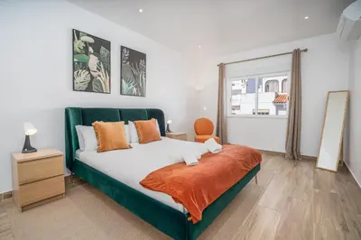 a chair sitting next to a lamp in a room at #034 Tebay by Home Holidays in Albufeira