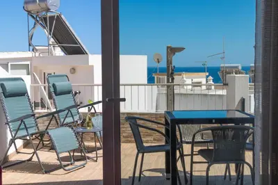 a beach with chairs and umbrellas on the sand at #044 T1 Rossio by Home Holidays in Albufeira