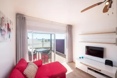 a balcony with chairs and a table and a view of the ocean at #044 T1 Rossio by Home Holidays in Albufeira