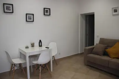a living room with a table and chairs and a couch at Quinta do Sr. Cabrita in Albufeira