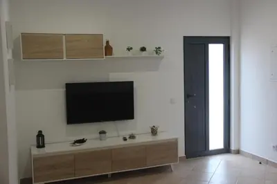 a living room with a flat screen tv on a wall at Quinta do Sr. Cabrita in Albufeira