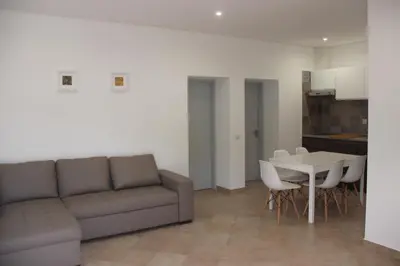 a living room with a couch and a table and chairs at Quinta do Sr. Cabrita in Albufeira
