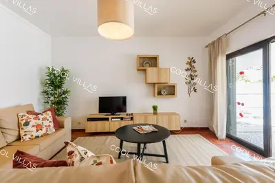 a living room with a couch and a table at Villa Margarida - heatable pool & city center in Albufeira