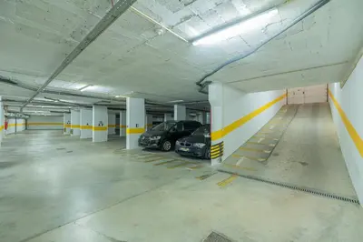 a parking garage with two cars parked in it at Histórical City Center Penthouse Albufeira in Albufeira