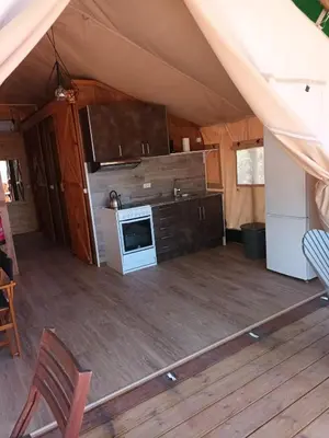 an interior view of a kitchen in a tent at Pérola de Sandy in Paderne