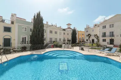 a large swimming pool in front of a building at Old Village Vilamoura in Quarteira
