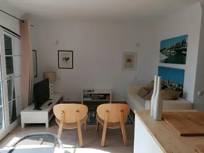 a dining room with a black and white table and chairs at Old Village Vilamoura in Quarteira