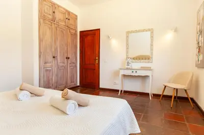 a bedroom with a bed and a desk and a mirror at Villa Palms by Algarve Vacation in Albufeira