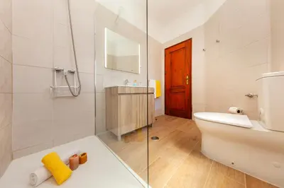 a bathroom with a toilet and a glass shower at Villa Palms by Algarve Vacation in Albufeira