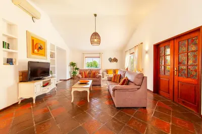 a living room with a couch and a tv at Villa Palms by Algarve Vacation in Albufeira