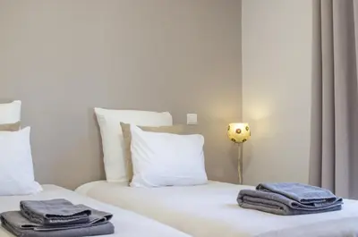 two beds in a room with towels on them at Villa Isabelle - Loule in Loulé