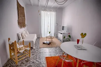 a living room with a table and a couch at Old Charming Faro Apartment in Faro